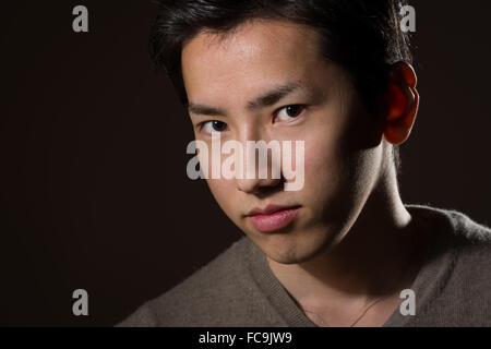 A headshot of a young handsome Japanese man. Stock Photo