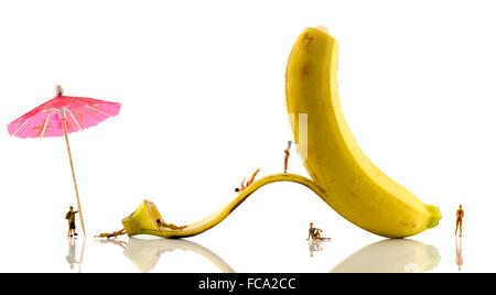 little people having fun on banana Stock Photo