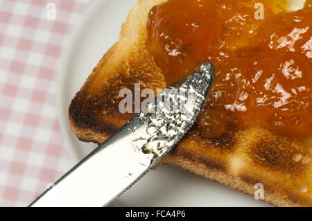 Spread jam on bread Stock Photo