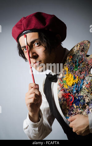 Funny artist in dark studio Stock Photo
