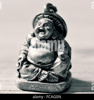 closeup of a laughing fat buddha in duotone Stock Photo