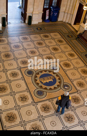 New Zealand, Dunedin. Historic Victorian Dunedin Railway Station, c. 1906. Interior view of tile floor. Stock Photo