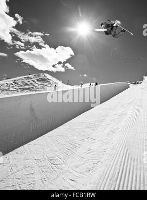 Snowboarder Riding Halfpipe. Stock Photo