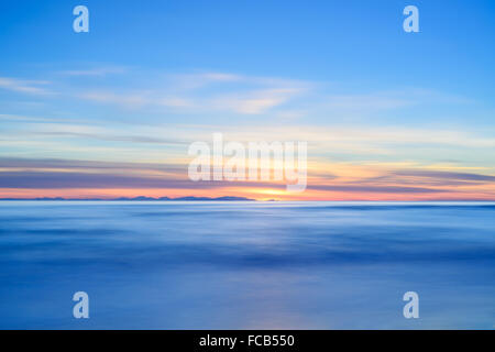 Corsica or Corse and Capraia islands view from Italian beach coast on twilight sunset time. Mediterranean sea, Tuscany, Italy, E Stock Photo