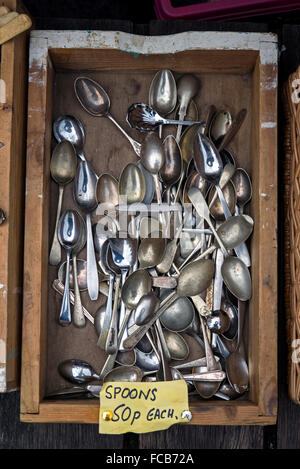 Boxes of cheap, secondhand cutlery for sale on a market stall in Edinburgh's Grassmarket. Stock Photo