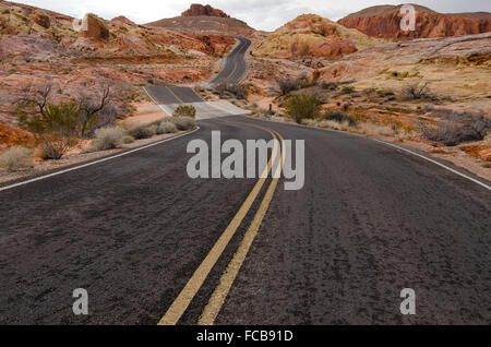 An empty desert road twists and curves through the Valley of Fire State Park. Stock Photo