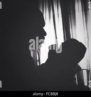 Side View Of Silhouette Man Holding Baby