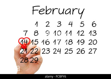 Hand drawing heart on February 14 on calendar with red marker on transparent wipe board. Valentines Day concept. Stock Photo