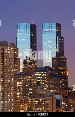 The Time Warner Center twin tower office building with residential scrapers in Midtown Manhattan at night  in New York City, USA Stock Photo