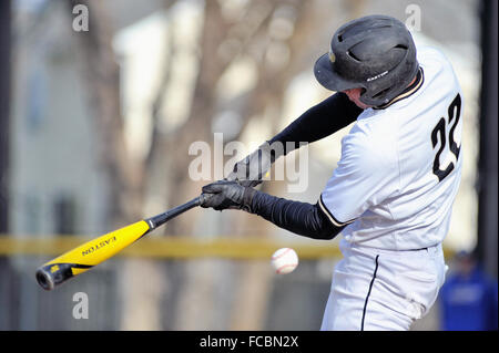 A batter swinging and missing a pitch during a high school baseball game. USA. Stock Photo