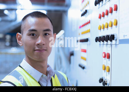 Portrait confident worker at control panel in factory Stock Photo