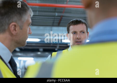 Workers talking in factory Stock Photo