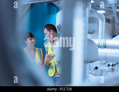 Workers talking in factory Stock Photo