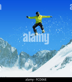 Snowboarder making jump high in clear sky Stock Photo