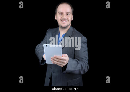 young man dark gray suit smiling pointing tablet Stock Photo