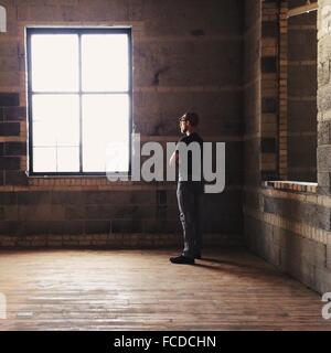 Side Profile Of A Man Looking Out Of Window