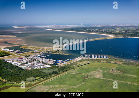 Netherlands, Stellendam, Background Rotterdam Port. Foreground Haringvliet Dam, belonging to the Delta Works. Aerial Stock Photo