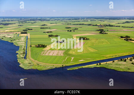 Netherlands, IJsselmuiden, Mound of IJssel river. Farmland and farms. Aerial Stock Photo