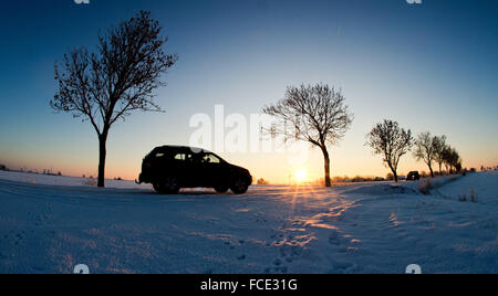 Sehnde, Germany. 22nd Jan, 2016. A car driving along a snowy and icy road close to Sehnde, Germany, 22 January 2016. PHOTO: JULIAN STRATENSCHULTE/dpa/Alamy Live News Stock Photo