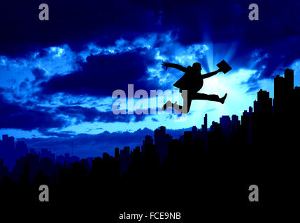 Silhouette of businessman jumping against sunset background Stock Photo