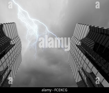 Bottom image of skyscraper with thunder lightning in sky Stock Photo