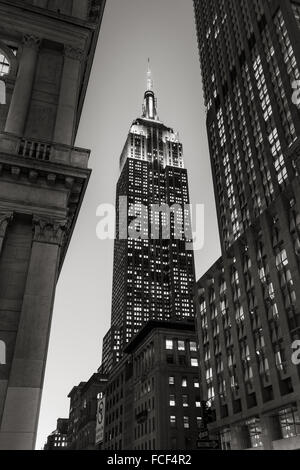 Black & White view of the Empire State Building skyscraper at twilight from 5th Avenue, Midtown, Manhattan, New York City Stock Photo