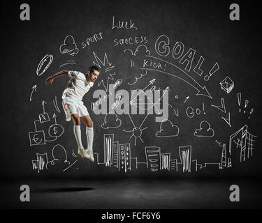 Football player in jump with sketches at background Stock Photo