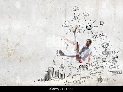 Football player in jump with sketches at background Stock Photo