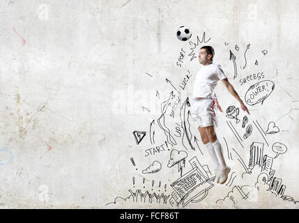 Football player in jump with sketches at background Stock Photo