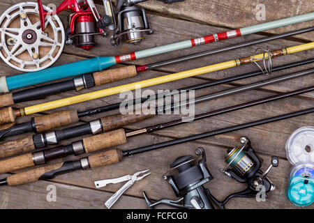Fishing rods and reels, fishing tackle on black wooden background Stock  Photo - Alamy