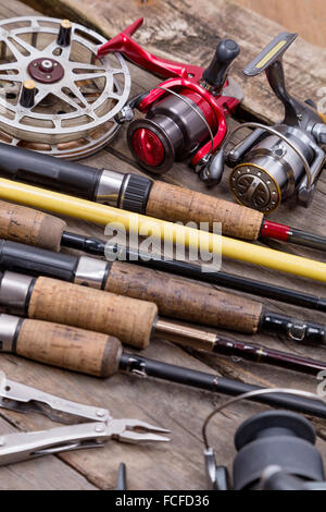 fishing rods and tackle on a wooden background Stock Photo - Alamy