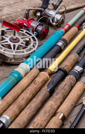 Different fishing rods on wooden background Stock Photo - Alamy