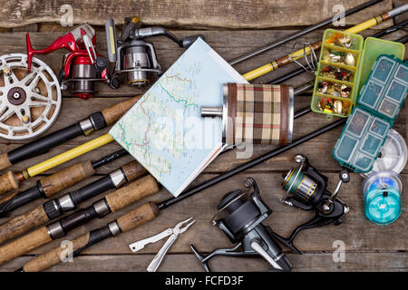 fishing rods and reels on wooden boards Stock Photo - Alamy