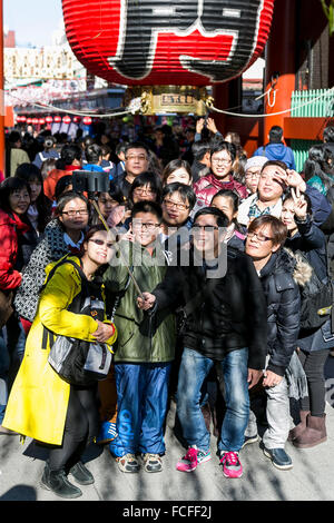 Tokyo, Japan. 22nd January, 2016. Asian tourists take a selfie at the entrance of Sensoji temple in Asakusa district on January 22, 2016, Tokyo, Japan. The Japan National Tourism Organization reported on Tuesday 19th a record increase in foreign visitors in 2015. Approximately 19.73 million people visited Japan from abroad, up 47.3 percent. According to the report there were more Chinese visitors than from any other nation with 4.99 million coming in 2015. Credit:  Aflo Co. Ltd./Alamy Live News Stock Photo