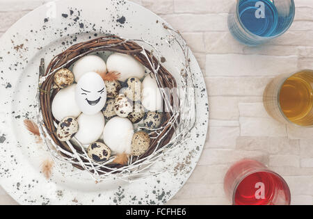 Coloring Easter Eggs.Preparing to dye eggs for Easter. Overhead view with retro style processing. Natural light Stock Photo