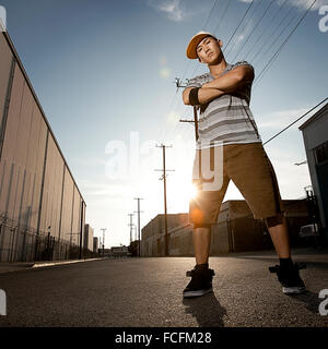 A young man, a breakdancer standing on a street with arms folded. Stock Photo