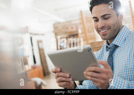 A man in shirt and tie holding a digital tablet. Stock Photo