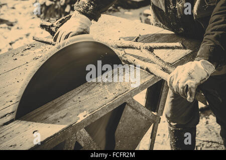 Man working with old handmade circular saw blade Stock Photo