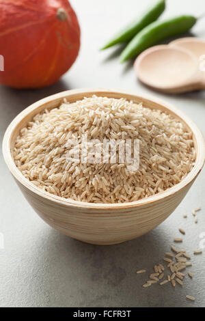 Raw brown rice in a bowl Stock Photo