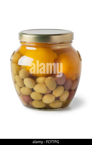 Moroccan glass jar with preserved olives and lemons on white background Stock Photo