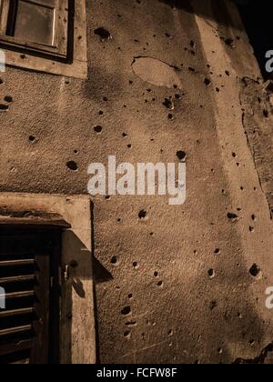 Gun shot holes on a gray concrete building in Sarajevo, Bosnia and Herzegovina, Europe. Stock Photo