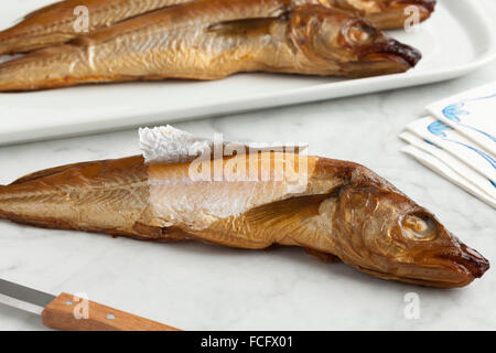 Fresh smoked whiting fish on the table Stock Photo
