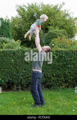 Father throwing his son in the air Stock Photo