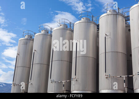 Giant industrial tanks on the bright blue sky background Stock Photo