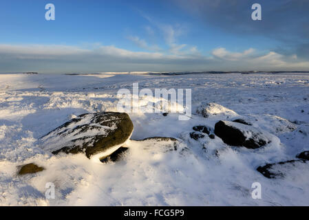 Snowy moorland beside the Pennine way above Glossop in Derbyshire on a breathtaking winter evening at sunset. Stock Photo