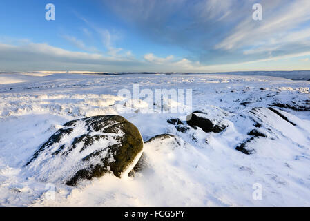 Snowy moorland beside the Pennine way above Glossop in Derbyshire on a breathtaking winter evening at sunset. Stock Photo