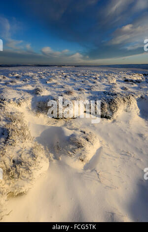 Snowy moorland beside the Pennine way above Glossop in Derbyshire on a breathtaking winter evening at sunset. Stock Photo