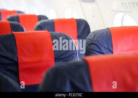 Blue airplane seats in an airplane cabin Stock Photo