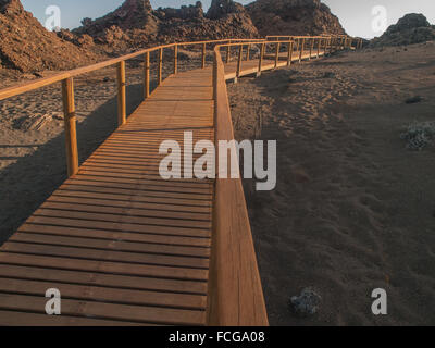 Wooden plank boardwalk with railing climbing uphill to a viewing platform on Bartolome, Galapagos Islands, Ecuador. Stock Photo