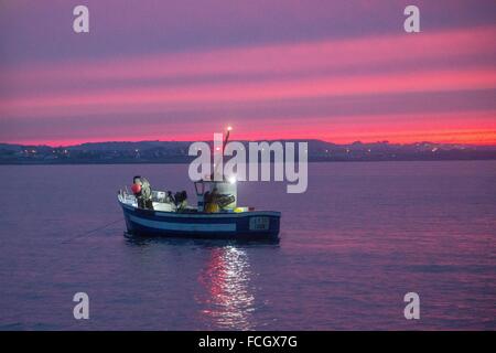 SHRIMP FISHER, FISHING AT SEA, SHRIMP TRAWLER AT DAWN OFF THE COAST OF LORIENT (56), BRITTANY, FRANCE Stock Photo